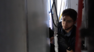 ice machine technician examines water line